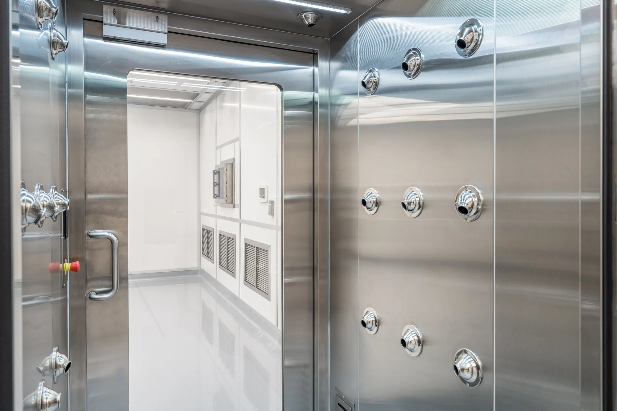 Stainless airlock into the Building 31 clean room, with pass-through ports along the wall.